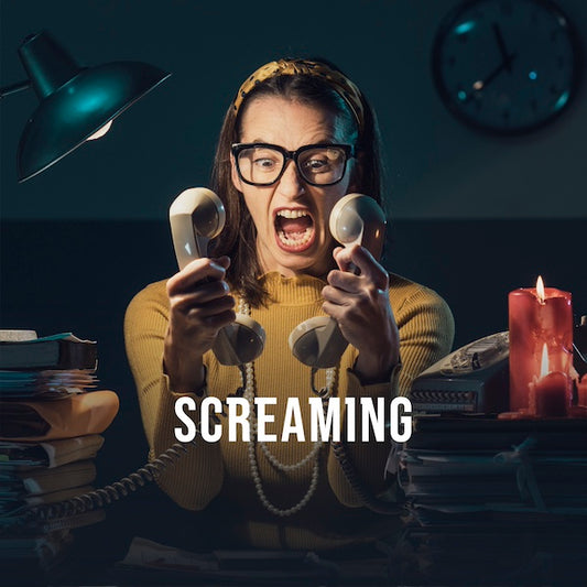 A person in a dark room holds two phones to her face and screams at them. Caption reads: screaming.